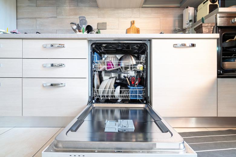 Opened dishwasher with clean dishes