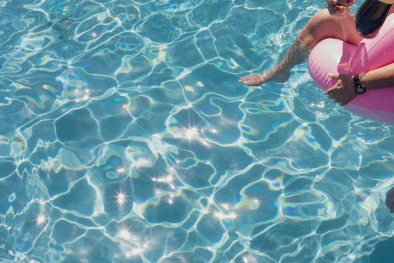 pool with person on a floatie nearby