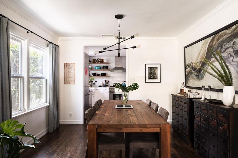 black and brown dining room with gray curtains and white walls