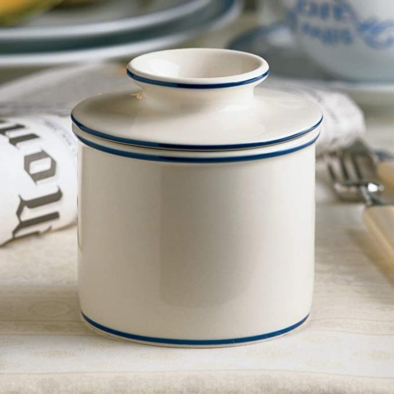 white ceramic butter bell with blue trim