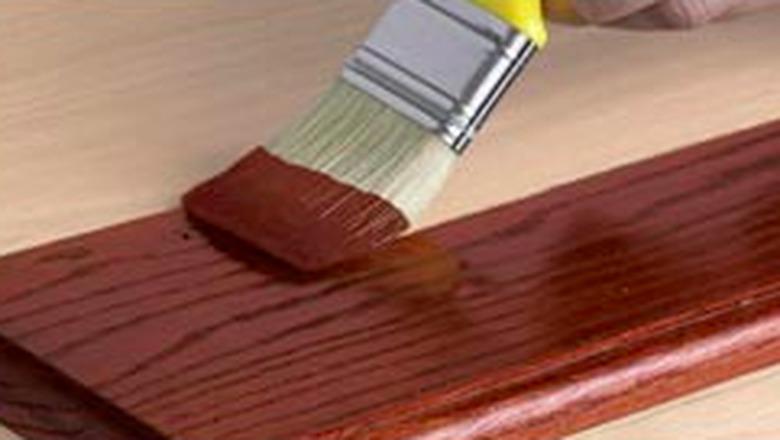 Staining wood with a brush.