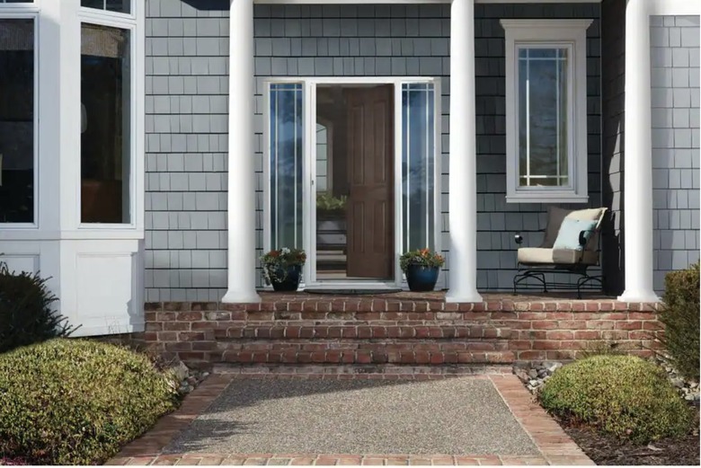 Retractable screen door on front porch with white columns