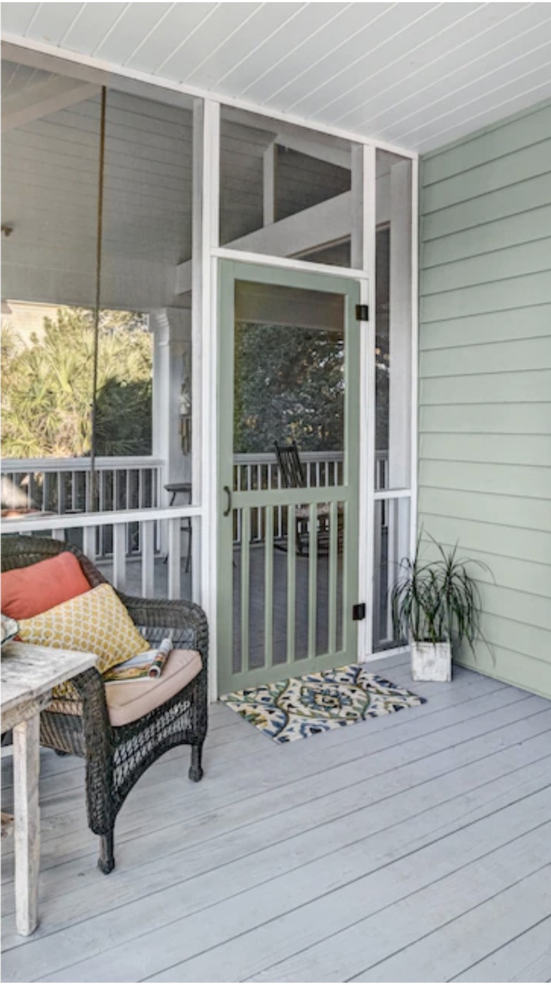 Hinged screen door on back patio