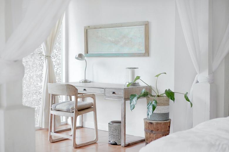 white home office idea with desk, chair, and plant