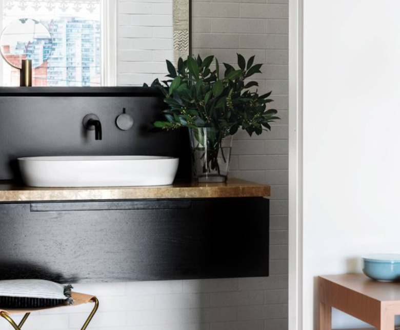 Wood painted a sleek black makes for a modern wood backsplash style.