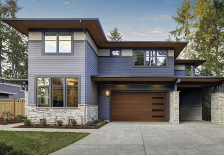 modern home with streamlined wooden garage door