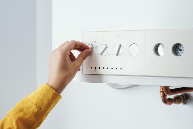 Woman checking settings on the boiler