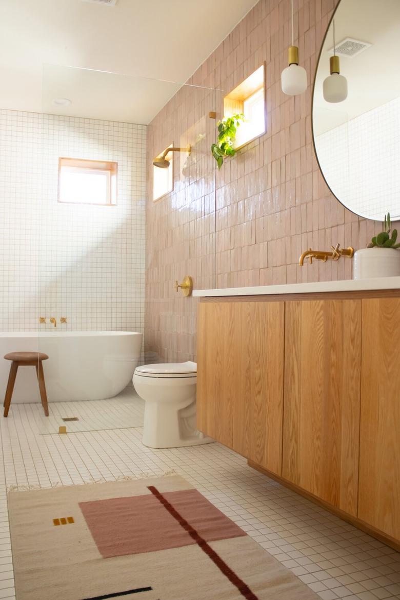 white and pink bathroom with zellige tiles and wooden vanity