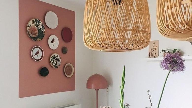 pink square painting on wall with plate art