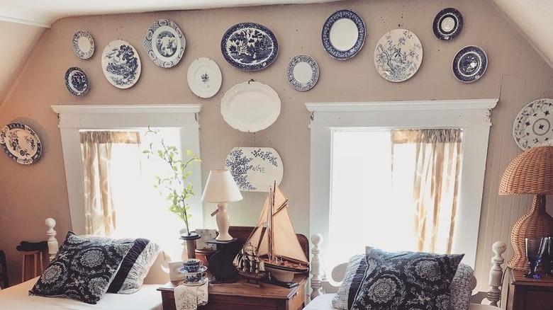 blue and white plates above windows and beds