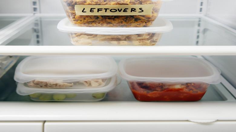 leftover food in plastic containers in the fridge