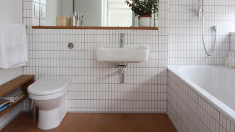 minimalist white bathroom with cork flooring