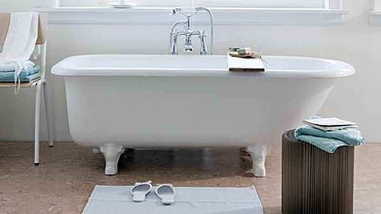 white bathroom with cork flooring and Roman shades