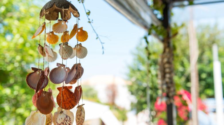 close up of seashells on string to create a wind chime