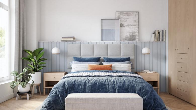 bedroom with accent wall shelf behind