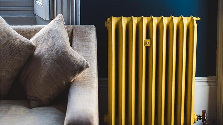 living room with yellow radiator and dark blue walls