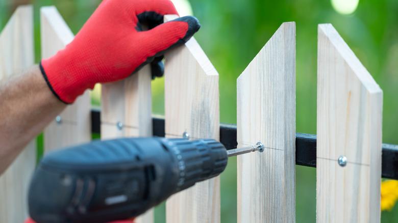 Repairs being done to backyard fence