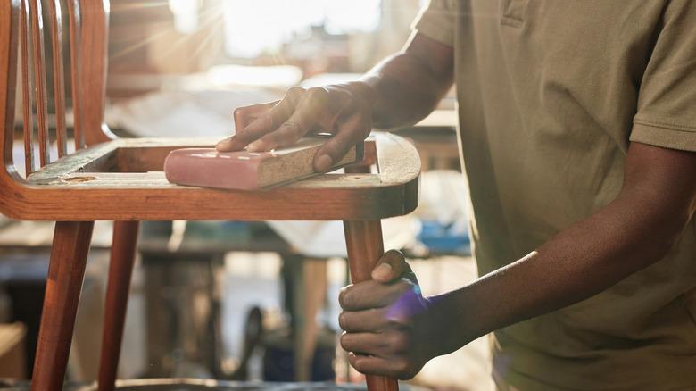 A person sanding wood.