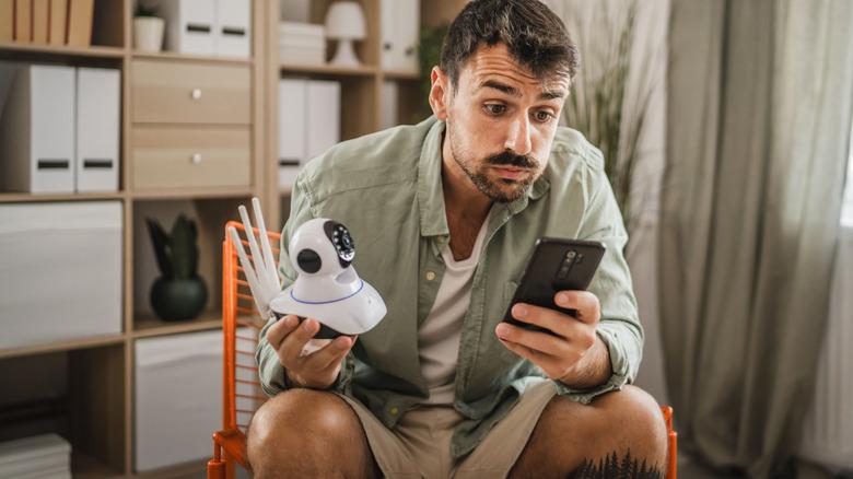 Frustrated man learning how to install a security camera