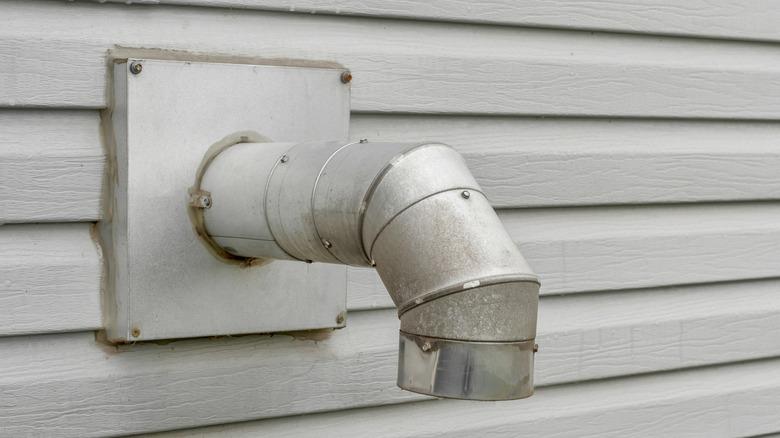 aluminum furnace vent sticking out of an exterior wall