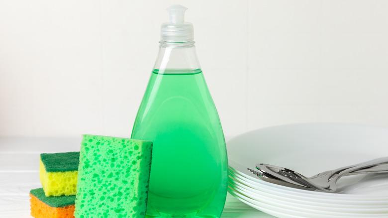 Sponges next to a bottle of green dish soap