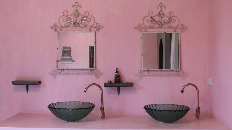 pink bathroom double vanity featuring gorgeous framed mirrors and black crystal vessel basin sinks