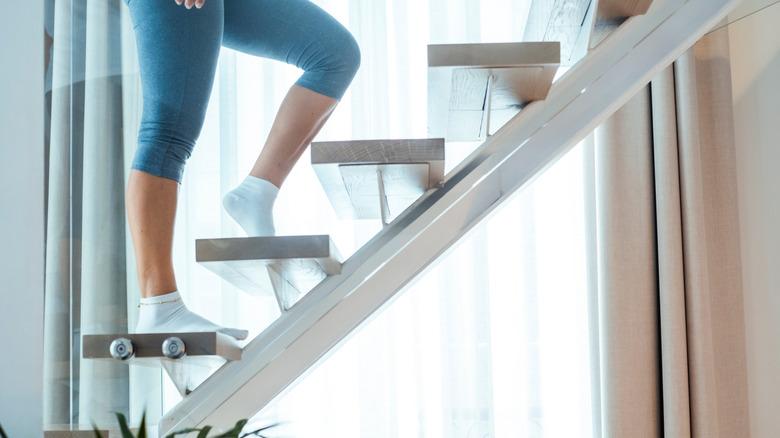 woman walking up death stairs