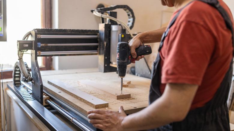 man setting up a CNC