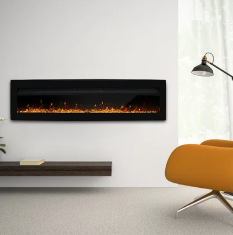 Electric fireplace on wall, reading lamp, lounge chair.