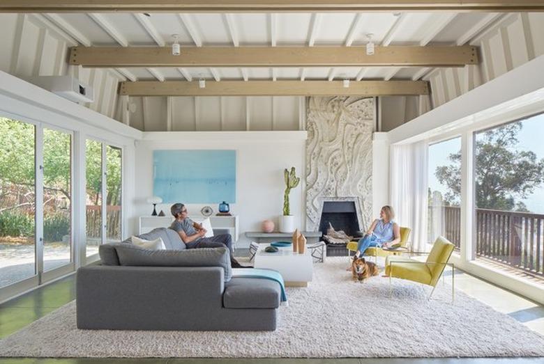 midcentury-style interior with large windows and fireplace