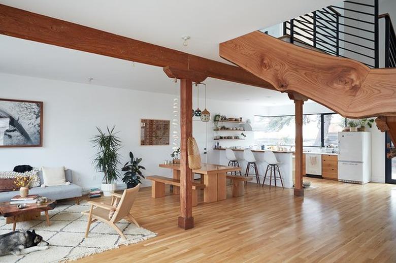 live-edge wood staircase in an open-concept living and kitchen area