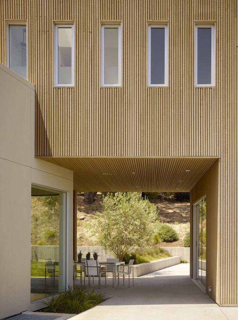 clean, minimal exterior with breezeway and outdoor dining set