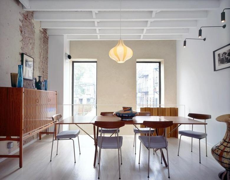 dining area with pendant lamp and modern wall sconces