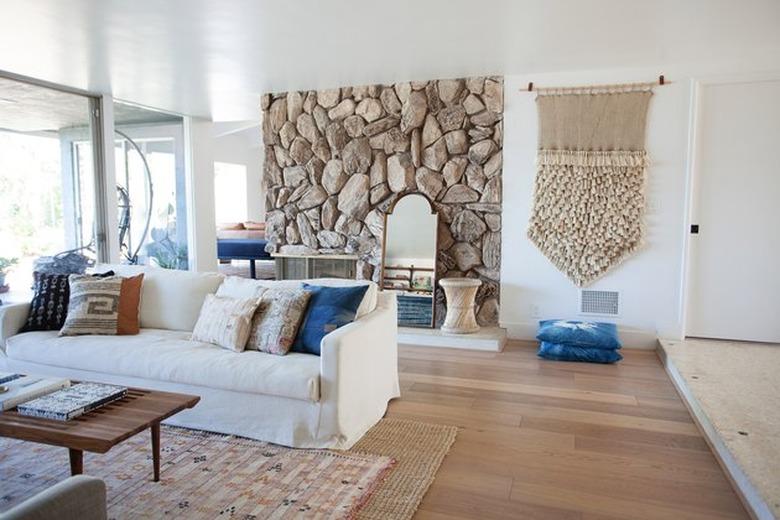 midcentury interior with neutral color palette and rock fireplace