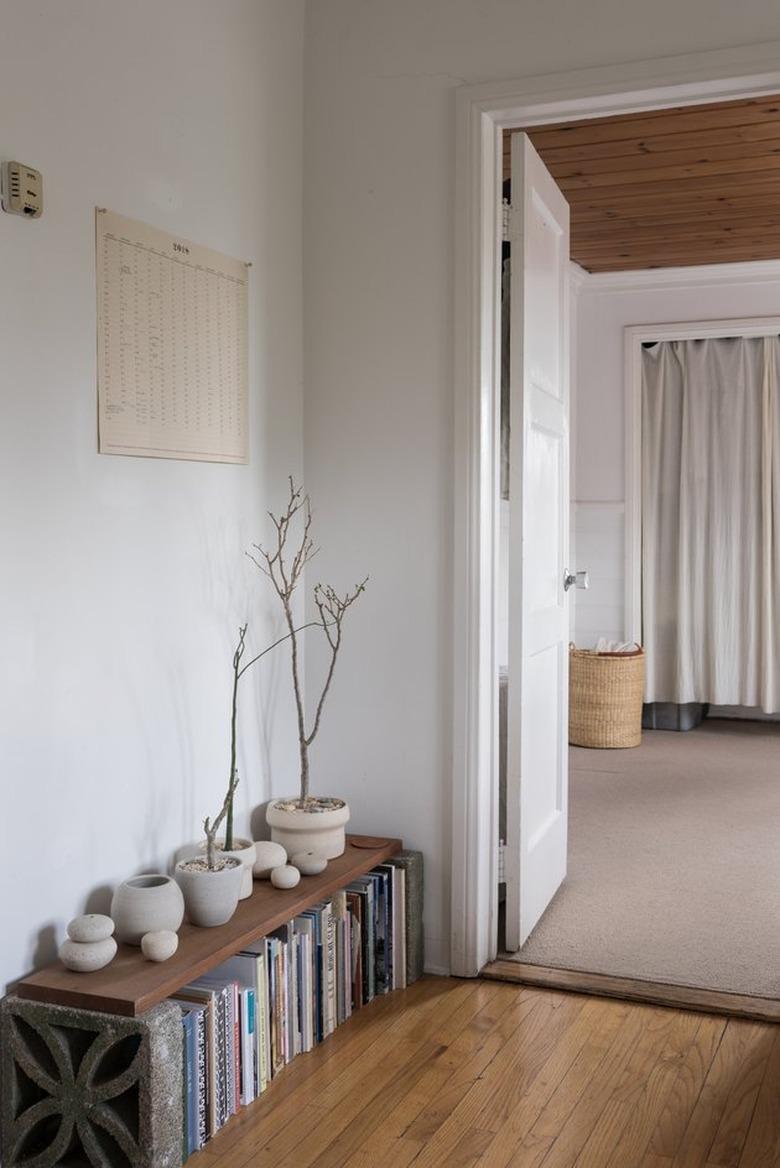 minimalist apartment with porcelain ceramics on a low bookshelf