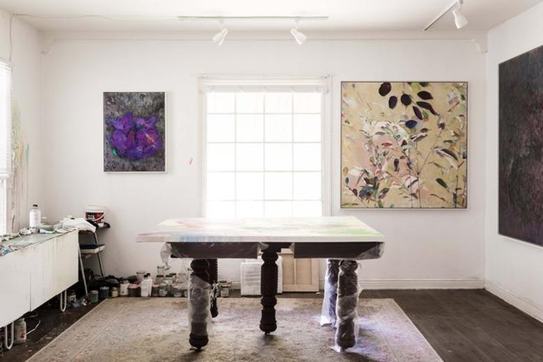 art studio in living room with art-filled walls