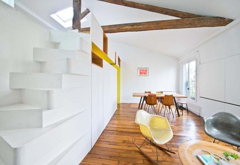 open living and dining room with staircase leading up to loft area