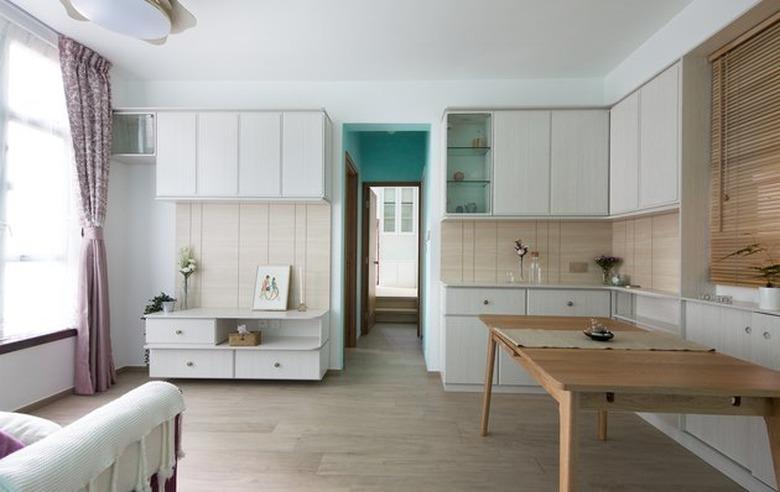 neutral apartment with wooden dining table and Tiffany blue accent wall