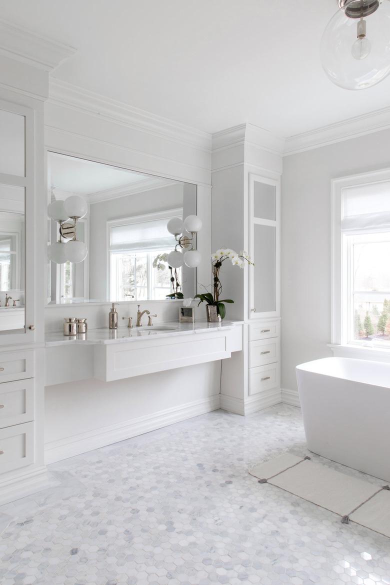 mosaic bathroom floor tile idea in white bathroom with freestanding tub