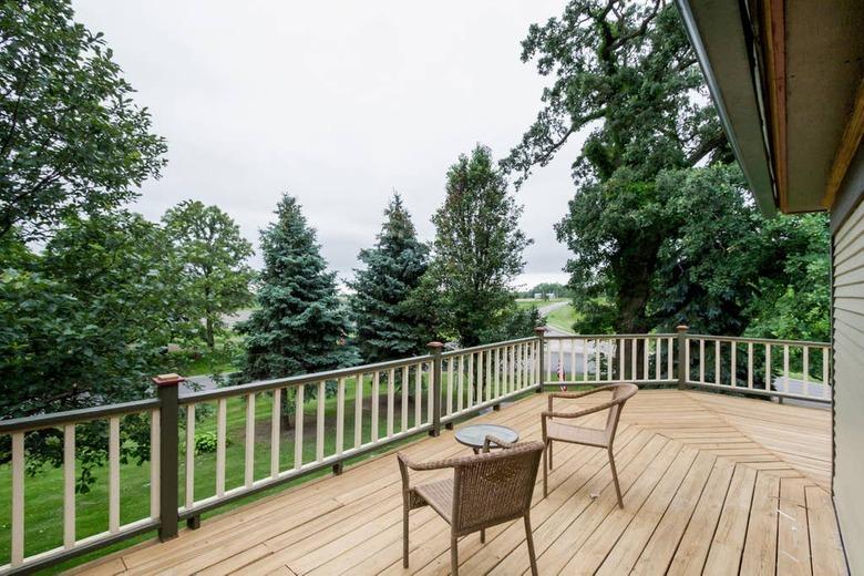 two chairs on patio with . trees nearby