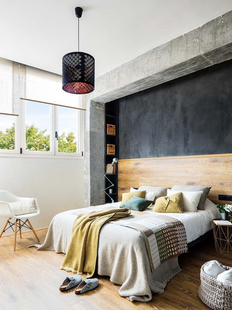 industrial bedroom with wood headboard and flooring