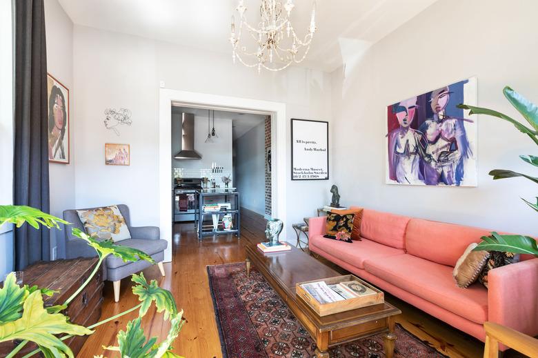 Living Room with gray walls and chandelier