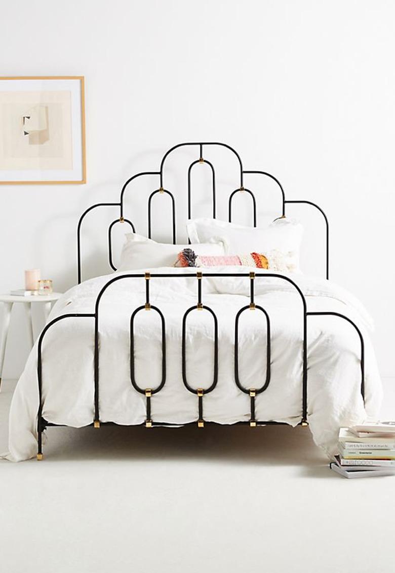 art deco bedroom with iron bed frame with gold detail