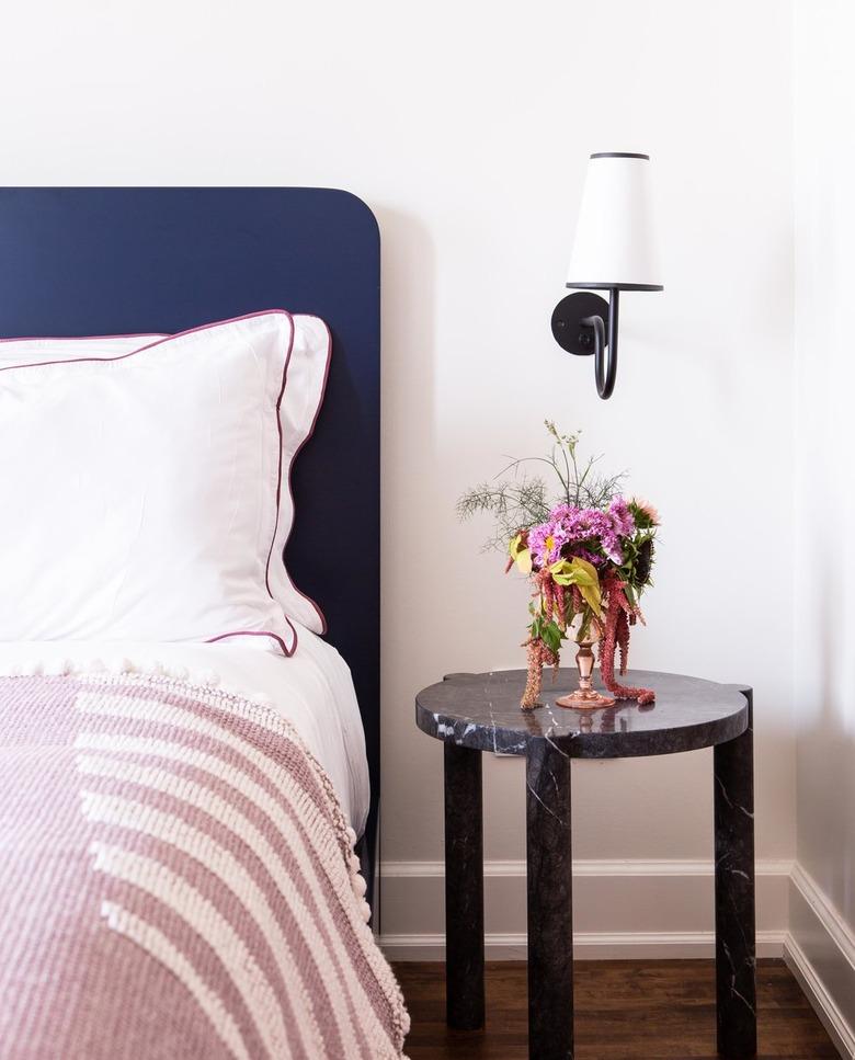 art deco inspired bedroom with black marble nightstand