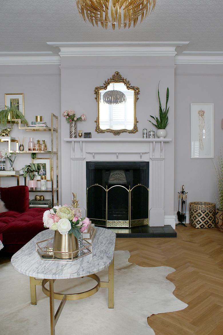 art deco living room with cowhide rug and gold accents