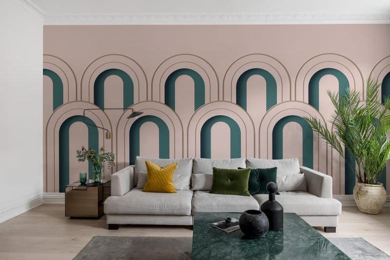 art deco living room with green arches on pink wall behind sofa