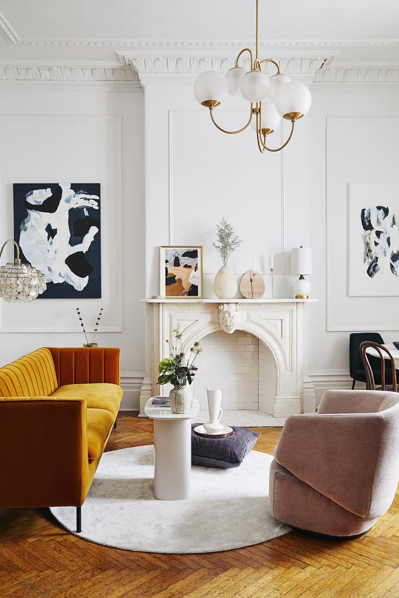 white art deco living room with orange sofa and wall art