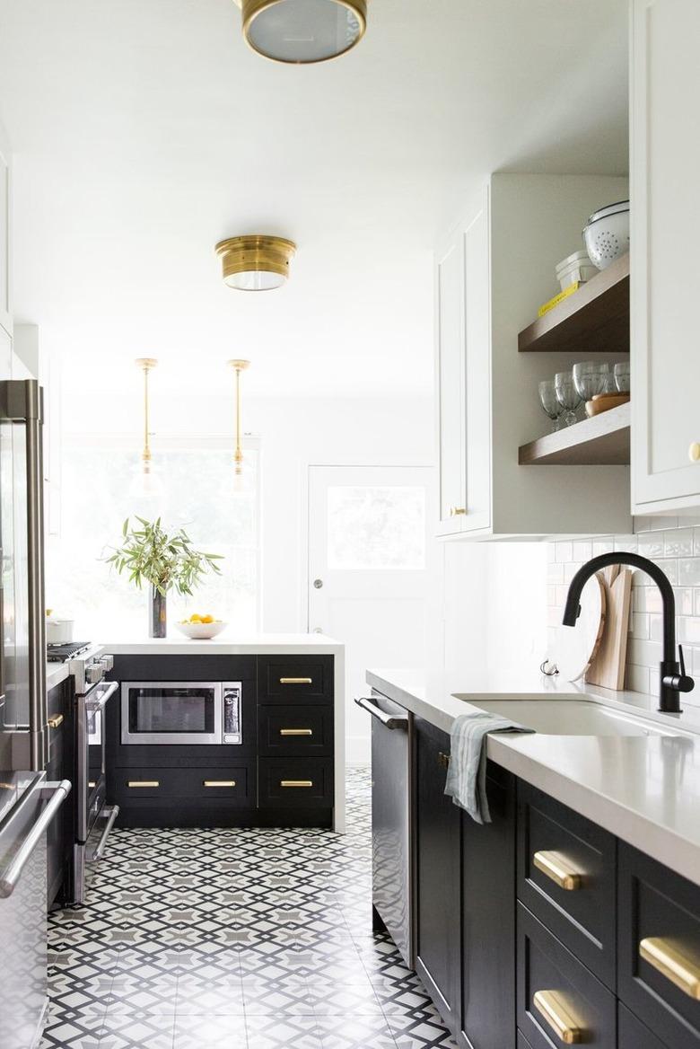 Black and white graphic art deco tile floor in black and white kitchen