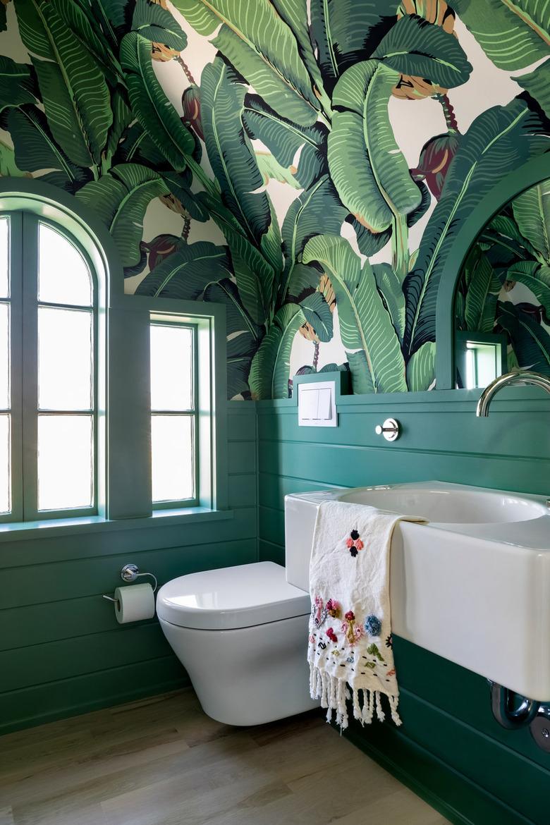 attic bathroom ideas with banana leaf wallpaper and green board and batten