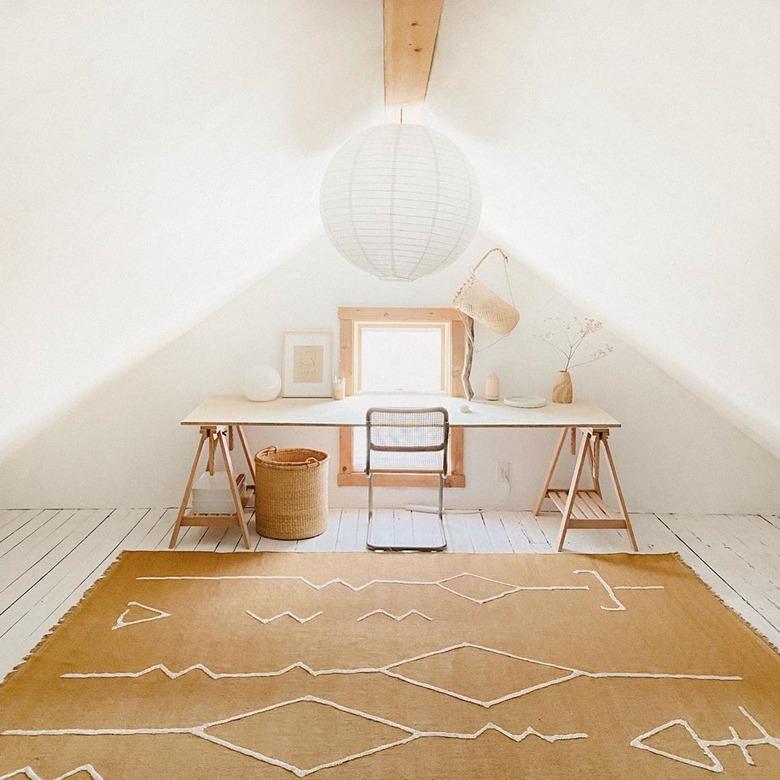 minimalist attic office idea with ochre rug and wood desk